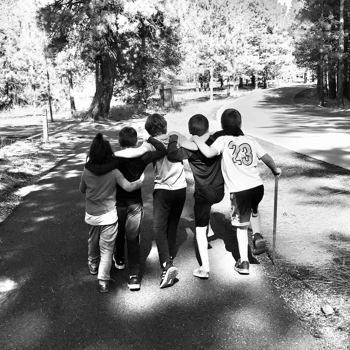Kids locking arms from behind__sq